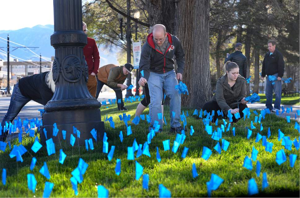 Scott Sommerdorf | The Salt Lake Tribune
Volunteers helped the Carmen B Pingree Autism Center of Learning to place some of the 16,000 blue flags on the lawn at Washington Square Park, Saturday, April 1 2017. The flags represent the 1 in 58 children in Utah who will be diagnosed with autism.