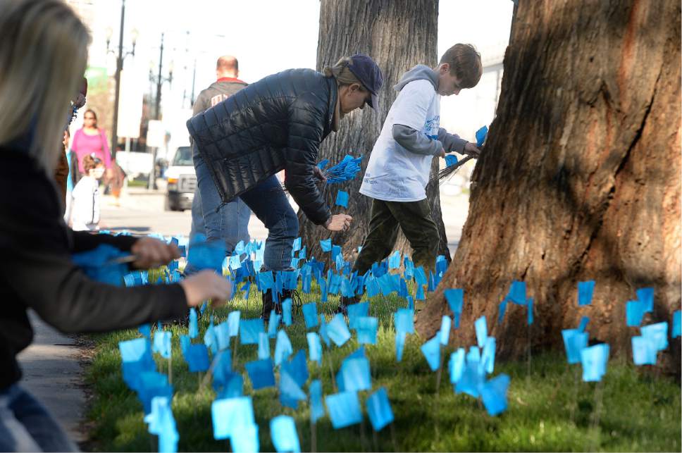 Scott Sommerdorf | The Salt Lake Tribune
Volunteers helped the Carmen B Pingree Autism Center of Learning to place some of the 16,000 blue flags on the lawn at Washington Square Park, Saturday, April 1 2017. The flags represent the 1 in 58 children in Utah who will be diagnosed with autism.