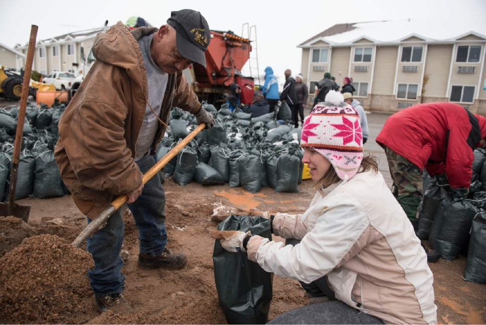 Lennie Mahler  |  The Salt Lake Tribune

Volunteers Celestno Ramirez and Laura Gough fill bags with sand to block flooding in Garden City, Utah, Friday, Feb. 10, 2017.