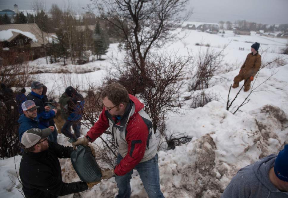 Lennie Mahler  |  The Salt Lake Tribune

Volunteers Jayson Gough and William Gough unload sandbags to block flooding in the Harbor Village neighborhood of Garden City, Utah, Friday, Feb. 10, 2017.