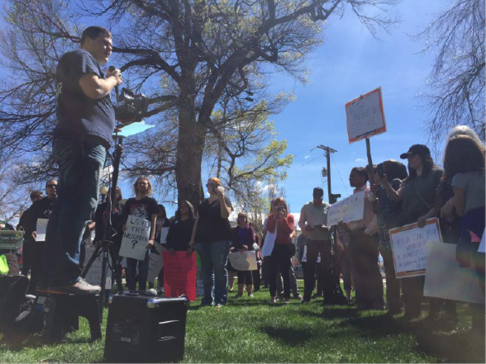 Luke Ramseth  |  The Salt Lake Tribune

Josh Haas, a social work student at Utah State University, speaks to the crowd Saturday at a Pioneer Park demonstration backing Utah's homes population.