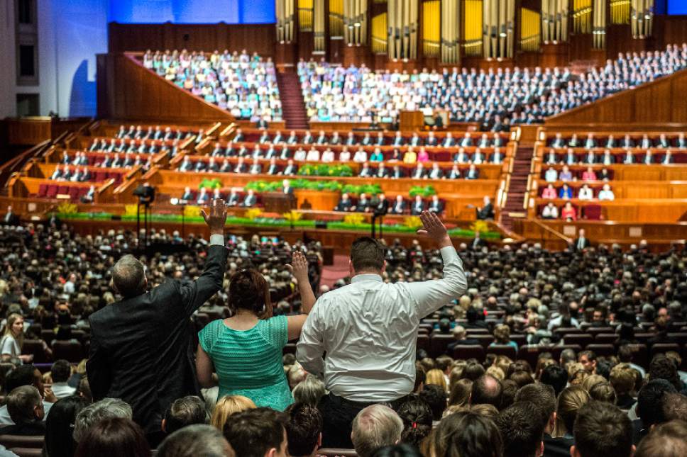 Chris Detrick  |  The Salt Lake Tribune
Three members stand up and say 'opposed' during the afternoon session of the 185th LDS General Conference Saturday April 4, 2015.