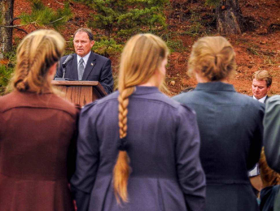 Trent Nelson  |  The Salt Lake Tribune
Utah Governor Gary Herbert speaks at a memorial for the victims of a Sept.  14 flash flood. At right is Joseph Jessop, who lost two wives and seven children in the flood. The memorial was held in Maxwell Park in Hildale, Saturday Sept. 26, 2015.