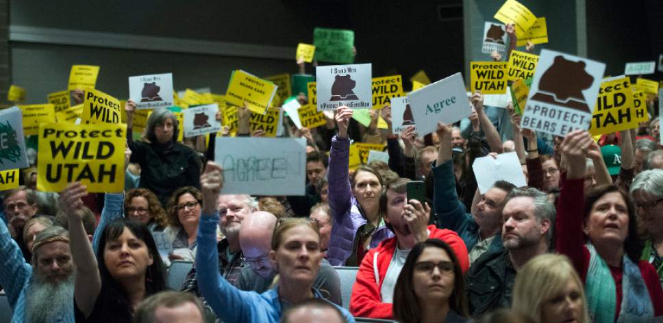 Chris Detrick  |  The Salt Lake Tribune
Members of the audience hold up signs at Rep. Chris Stewart during a town hall meeting at West High School Friday March 31, 2017.