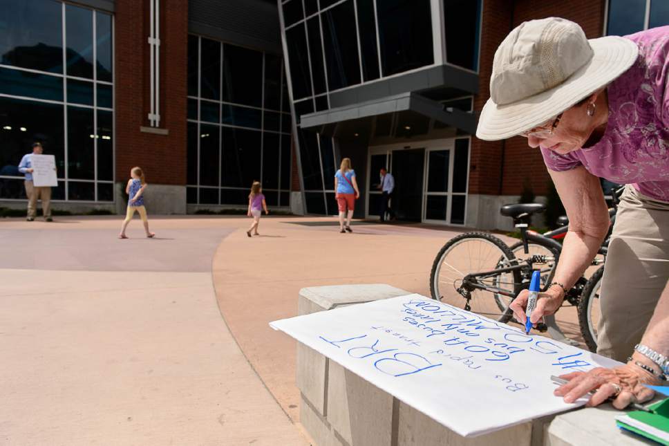 Trent Nelson  |   Tribune file photo
Sharon Anderson makes a sign on the grounds of the Provo Recreation Center in Provo in June as part of the protest movement pushing a referendum to stop a controversial transit project in Provo and Orem.
