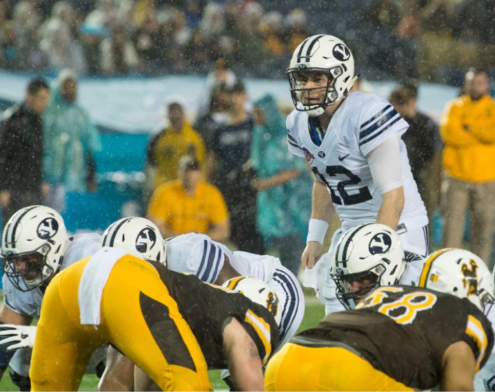 Rick Egan  |  The Salt Lake Tribune

Brigham Young Cougars Brigham Young Cougars quarterback Tanner Mangum (12) examine the defense, before running for a BYU touchdown, in the Poinsettia Bowl, at Qualcomm Stadium in San Diego, December 21, 2016.