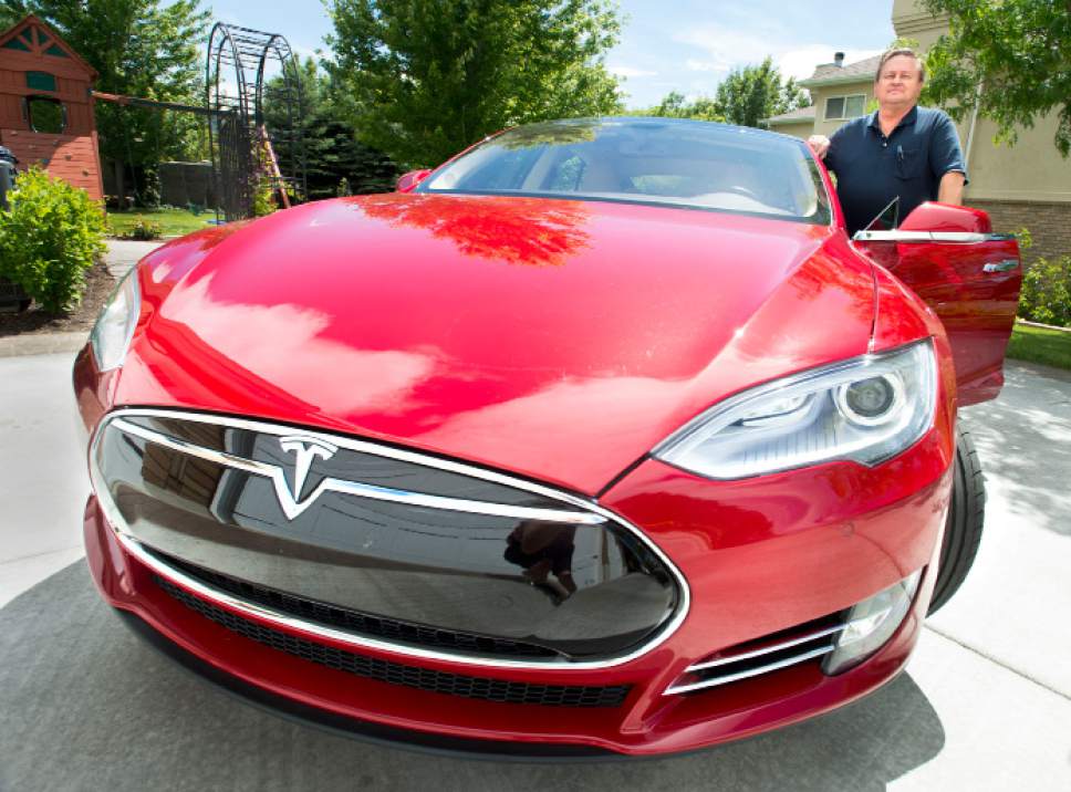Steve Griffin  |  The Salt Lake Tribune


Rick Votaw stands withf his new $140,000 all-electric Tesla car in his Sandy, Utah home Friday, June 20, 2014. Votaw thought the car would qualify him for a clean air decal to allow free use of freeway express lanes. But UDOT has said it has reached its limit for those stickers, so it won't give him one.