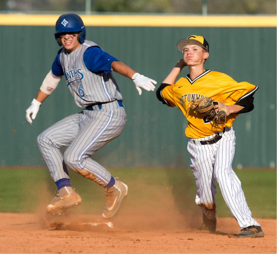 Rick Egan  |  The Salt Lake Tribune

Cottonwood short-stop Cade Perkins (22) throws to first, after forcing out base runner, Chad Wilson (6) Bingham, in prep baseball action, Bingham vs. Cottonwood, Wednesday, April 5, 2017.