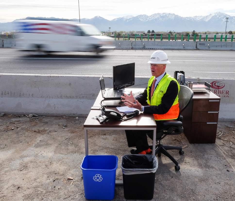 Francisco Kjolseth | The Salt Lake Tribune
In an effort to promote safety in highway construction zones, UDOT Executive Director Carlos Braceras temporarily moved his "office" to the middle of a busy freeway as part of National Work Zone Safety week. The briefing conducted in the I-215 construction zone was done to encourage drivers to use caution for their safety as well as construction crews.