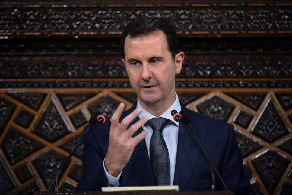 FILE - In this June 7, 2016 file photo released by the Syrian official news agency SANA, Syrian President Bashar Assad, addresses a speech to the newly-elected parliament at the parliament building, in Damascus, Syria.  Assad's government came under mounting international pressure Thursday, April 6, 2017 after a chemical attack in northern Syria, with even key ally Russia saying its support is not unconditional. (SANA via AP)