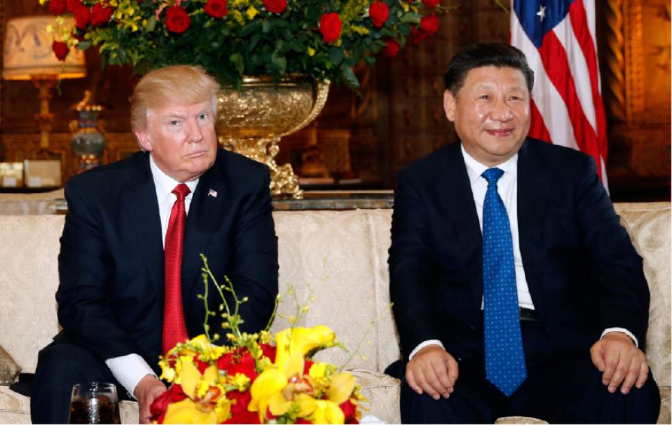 President Donald Trump and Chinese President Xi Jinping, sit as they pose for photographers before a meeting at Mar-a-Lago, Thursday, April 6, 2017, in Palm Beach, Fla. (AP Photo/Alex Brandon)