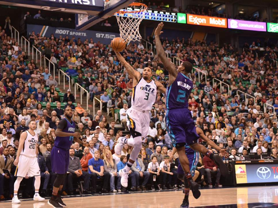 Lennie Mahler  |  The Salt Lake Tribune

George Hill goes up hard and is fouled by Charlotte's Marvin Williams in a game at Vivint Smart Home Arena on Saturday, Feb. 4, 2017.