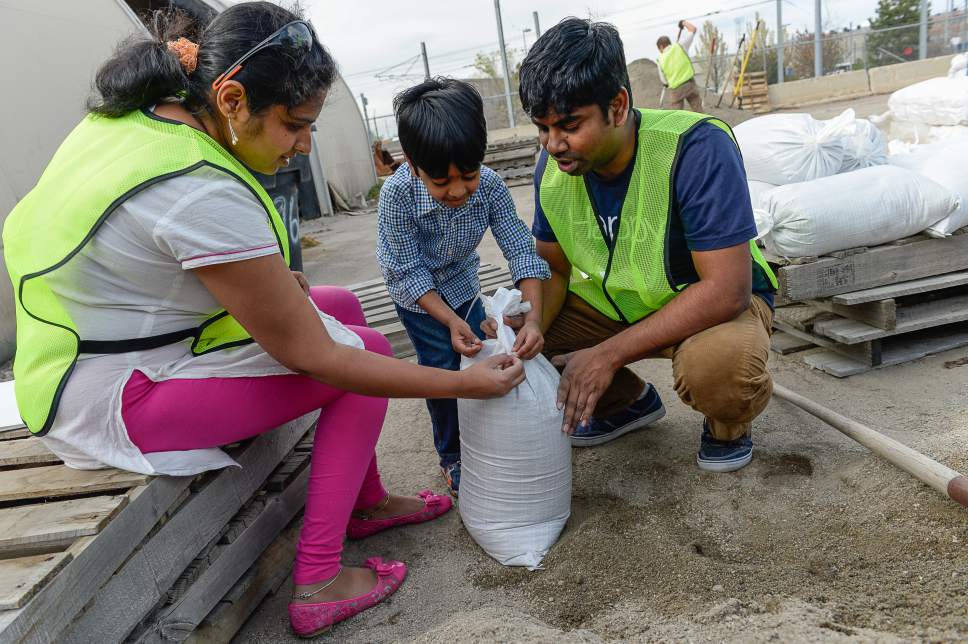 Francisco Kjolseth |  The Salt Lake Tribune
Volunteers fill bags with sand to block flooding expected to come with the snow melt.