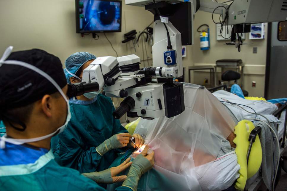 Chris Detrick  |  The Salt Lake Tribune
Dr. Craig Chaya and Dr. Eileen Hwang perform cataract surgery on Johnny Mahoney, of Salt Lake City, at the Moran Eye Center Saturday, April 8, 2017.  John A. Moran Eye Center surgeons provided free, sight-restoring surgeries for twenty-three cataract patients as part of Operation Sight Day, a twice-yearly event assisting low-income, uninsured Utahns in need of care.