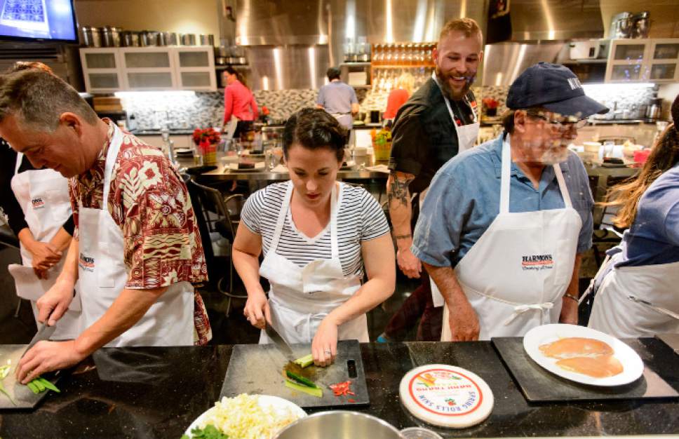 Steve Griffin  |  The Salt Lake Tribune
Harmons Cooking School chef Evan Francois checks up on his students during a Chinese 101 cooking class at the City Creek store in Salt Lake City on Wednesday, April 5, 2017. Harmons is the first grocery store in Utah to get a full-service restaurant liquor license. The new license will allow students in the grocer's City Creek cooking school to buy a glass of wine or bottle of beer to enjoy during any class they attend.