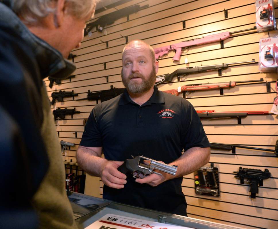 Al Hartmann  |  Tribune file photo
Stuart Wallin, owner of Get Some Guns and Ammo helps customer with advice on a handgun at the flagship store in Murray Friday Jan. 8.  Gun sales in Utah spiked in 2015, but didn't top the highs in 2012 and 2013. Both spikes appear to be in reaction to terrorist attacks and calls for gun control by President Barack Obama.