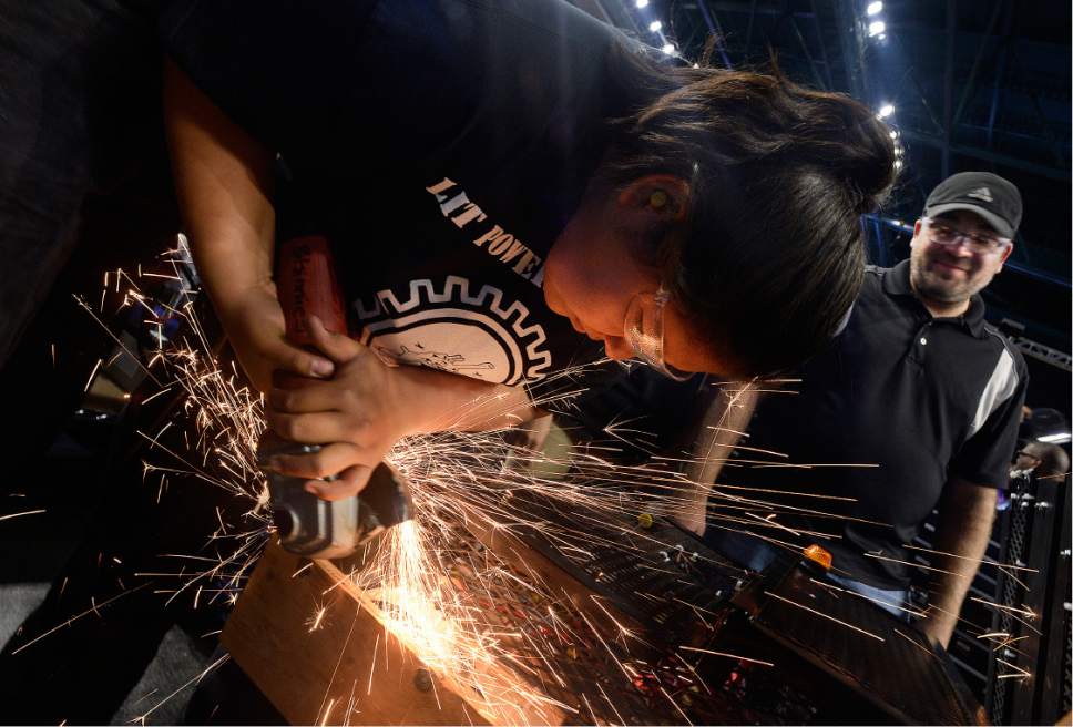 Scott Sommerdorf | The Salt Lake Tribune
Breana Bitsinnie throws some sparks off as she grinds down a stubborn bolt as the team attaches new bumpers to the robot. The Navajo Mountain High School robotics team competes at the "Utah FIRST Robotics Competition," Thursday, March 9, 2017. Mentor Daniel Conrad watches at right.