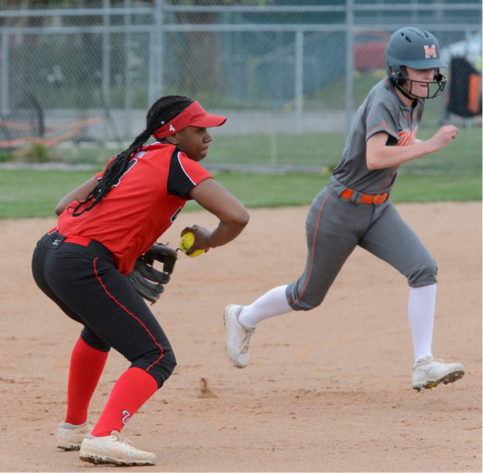 Steve Griffin  |  The Salt Lake Tribune
West shortstop Jazmyn Rollin flips a backhanded throw to third base to force out Murray's Preslee Jensen during the West versus Murray softball game at West High School in Salt Lake City, Friday, April 7, 2017.