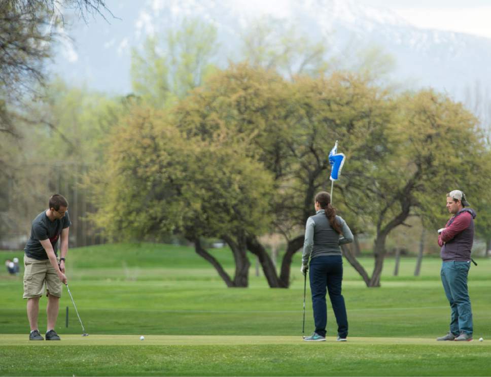 Rick Egan  |  The Salt Lake Tribune

 Ryan Blaser, Rebecca Hartman and Jason Christensen, play a round of golf at Nibley Park Golf Course, Friday, April 7, 2017.