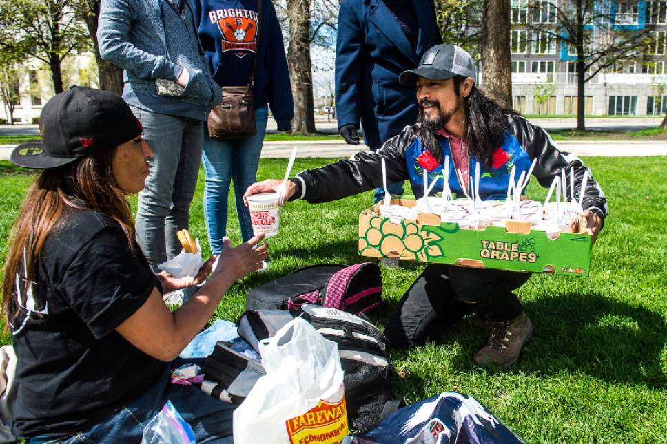 Chris Detrick  |  The Salt Lake Tribune
Volunteer Carl Moore, chairperson of PANDOS, hands out Cup of Noodles to Ramona Delafuente at Pioneer Park Sunday, April 9, 2017.  Over thirty volunteers helped hand out 300 meals to homeless people around Pioneer Park and the Road Home.