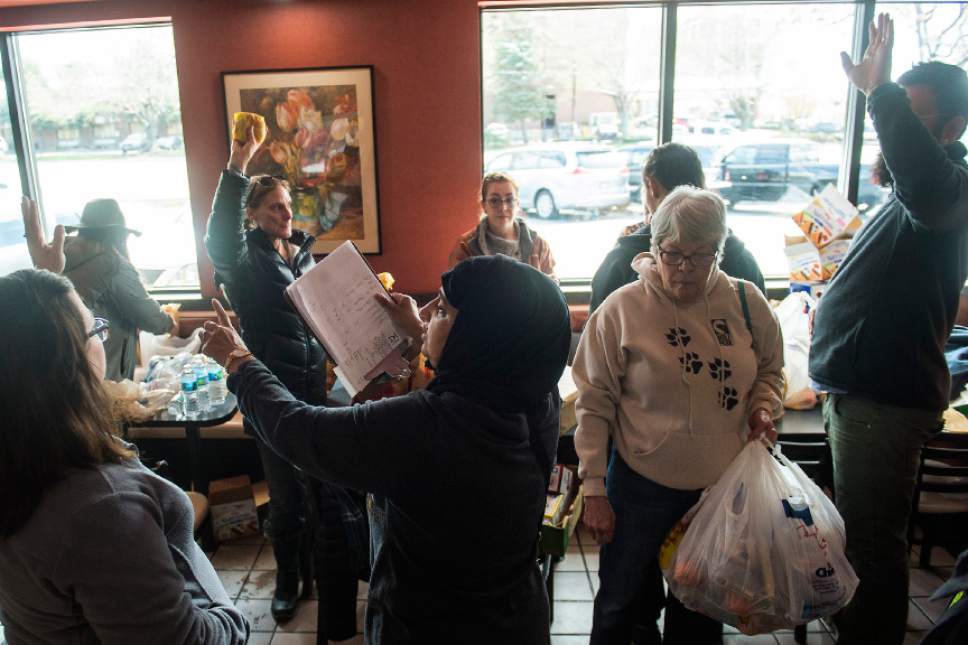 Chris Detrick  |  The Salt Lake Tribune
Noor Ul-Hasan, center, helps to organize volunteers at McDonalds in Salt Lake City Sunday, April 9, 2017.  Over thirty volunteers helped hand out 300 meals to homeless people around Pioneer Park and the Road Home.