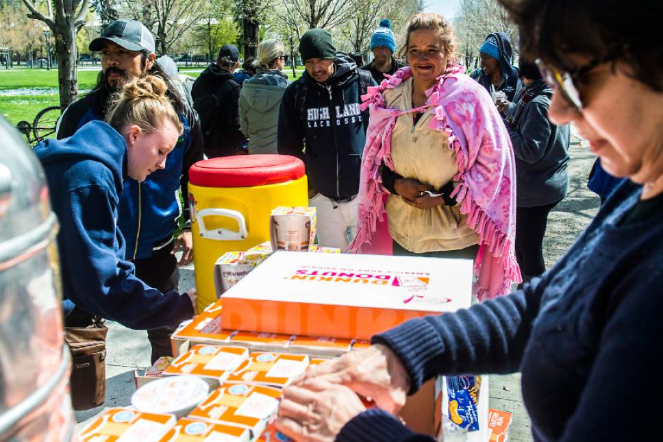 Chris Detrick  |  The Salt Lake Tribune
Allie Stephens, center, of Salt Lake City, waits to receive a Cup of Noodles at Pioneer Park Sunday, April 9, 2017.  Over thirty volunteers helped hand out 300 meals to homeless people around Pioneer Park and the Road Home.