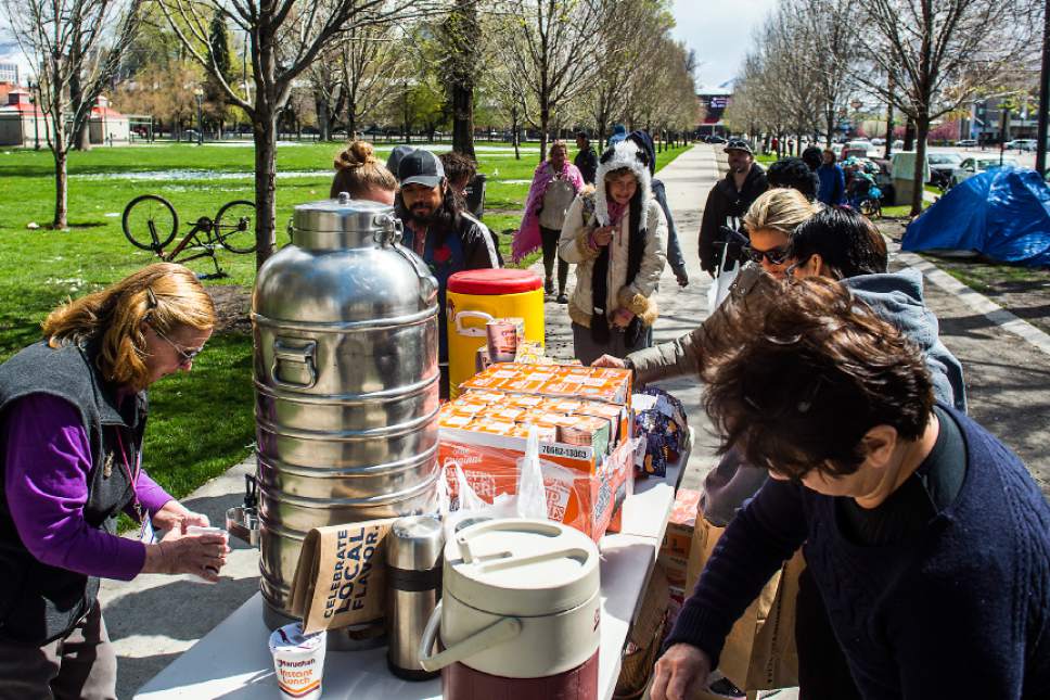 Chris Detrick  |  The Salt Lake Tribune
Volunteers prepare Cup of Noodles to hand out to homeless individuals at Pioneer Park Sunday, April 9, 2017.  Over thirty volunteers helped hand out 300 meals to homeless people around Pioneer Park and the Road Home.