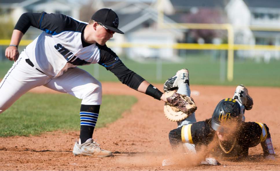 Rick Egan  |  The Salt Lake Tribune

Stansbury Park first baseman  Clayton Stanworth puts on a tag, as Carter Arnold (6) Union dives safely back to first, in prep baseball action, Union vs Stansbury, Monday, April 10, 2017.