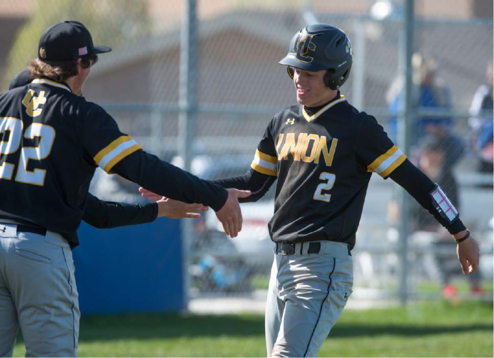 Rick Egan  |  The Salt Lake Tribune

Logan Duncan (22) Union, congratulates Lincoln Labrum (2) after scoring, in prep baseball action, Union vs Stansbury, Monday, April 10, 2017.