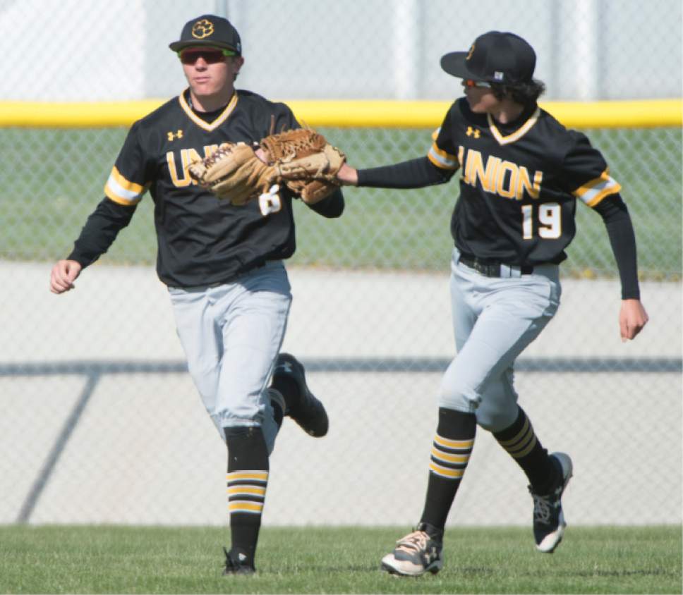 Rick Egan  |  The Salt Lake Tribune

Braiden Nebeker (19) Union, congratulates center fielder Cole Bertoch (8) after his catch in deep centerfield, in prep baseball action, Union vs Stansbury, Monday, April 10, 2017.