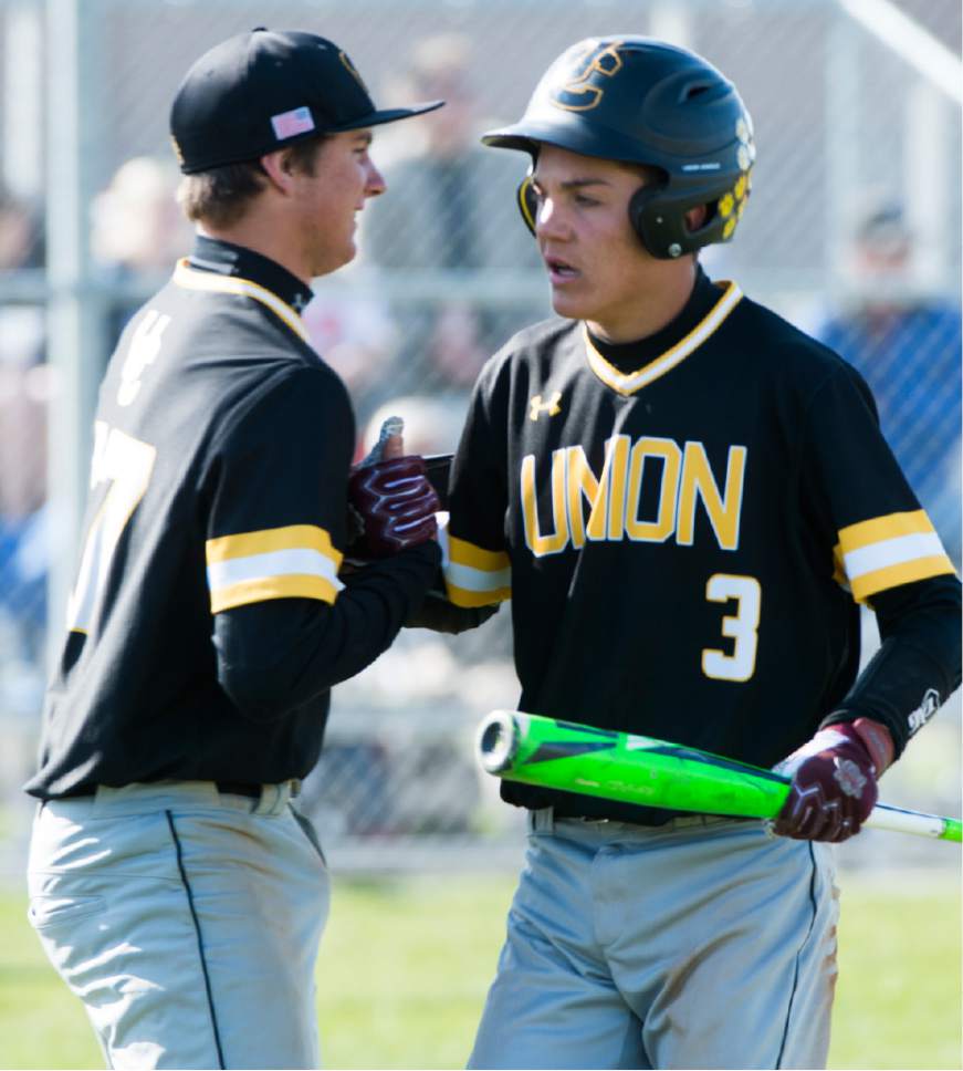 Rick Egan  |  The Salt Lake Tribune

Easton Rohrer (17) Union, congratulates Gage Roberts (3) after Roberts scored the tying run in the sixth inning, in prep baseball action, Union vs Stansbury, Monday, April 10, 2017.