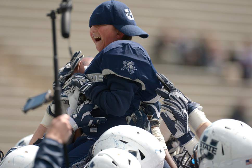Leah Hogsten  |  The Salt Lake Tribune 
Jacob Knight, 11, got to meet the team and make a touchdown as running back for the Blue team during Utah State University football team's annual Blue vs. White Spring Game, Saturday, April 8, on Merlin Olsen Field at Maverik Stadium.
