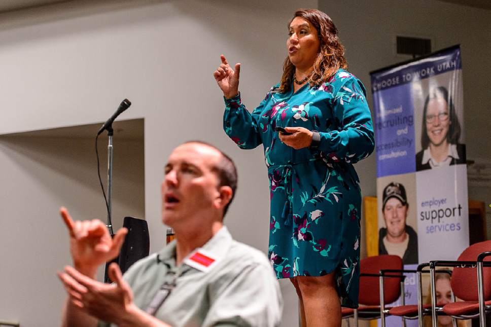 Trent Nelson  |  The Salt Lake Tribune
Leah Lobato, Director of the Governor's Committee on the Employment of People with Disabilities and Business Relations, gives job advice while Chip Royce interprets in ASL at the Work Ability Career Exploration & Job Fair at the Sanderson Center in Taylorsville, Tuesday April 11, 2017.