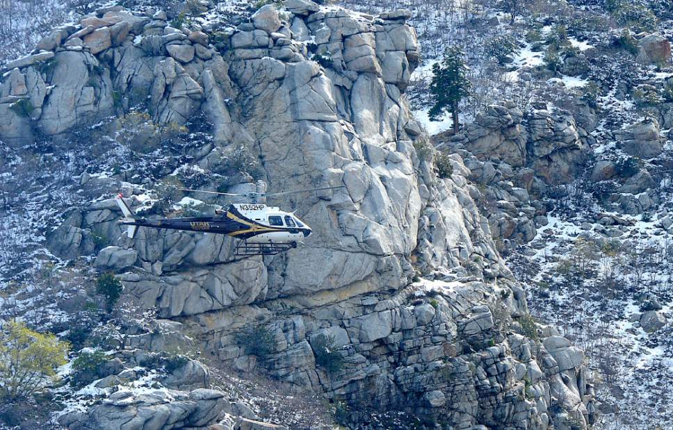 Al Hartmann  |  The Salt Lake Tribune
Utah Department of Public Safety helicopter passes slowly over cliffs in Ferguson Canyon Monday April 10 in the resumed search for a Saratoga Springs man Benjamin Kritzer, 28 who has been missing since Thursday on a solo hike in the mountains above Cottonwood Heights.