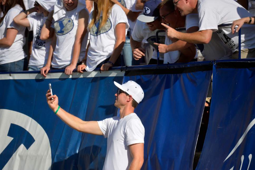 Chris Detrick  |  The Salt Lake Tribune
Jimmer Fredette takes a selfie with fans during the second half of the game at LaVell Edwards Stadium Saturday September 20, 2014.  BYU won the game 41-33.