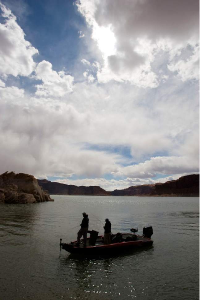 Al Hartmann  |  The Salt Lake Tribune
Big water and big sky dwarf a lone fishing boat in Good Hope Bay at Lake Powell.