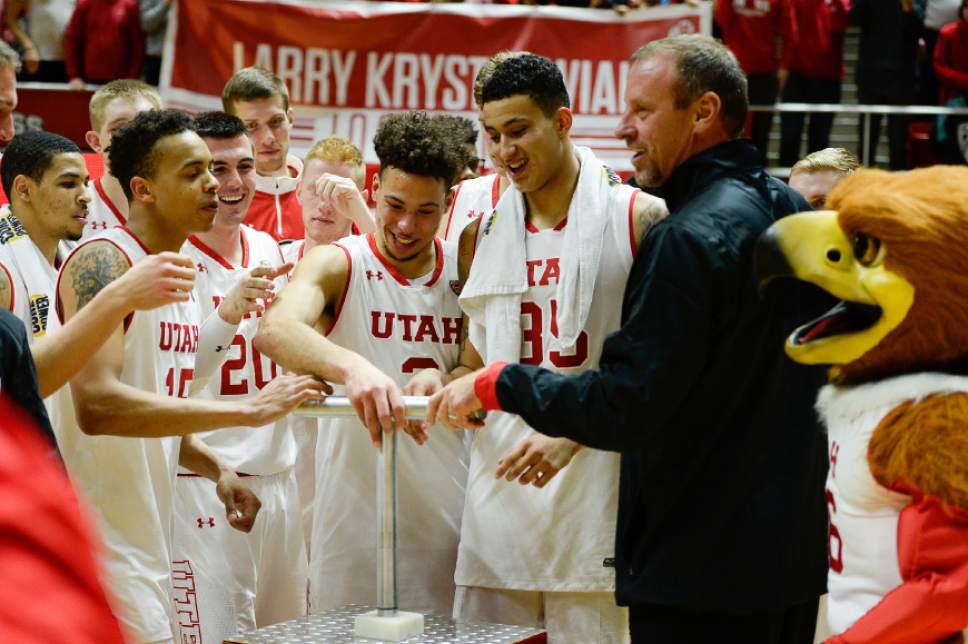 Francisco Kjolseth | The Salt Lake Tribune
Utah celebrates their win over Montana State 92-84 and the 100 career win for coach Larry Krystkowiak as they light up the "U" in NCAA basketball at the Huntsman Center in Salt Lake City on Thursday, Dec. 1, 2016.