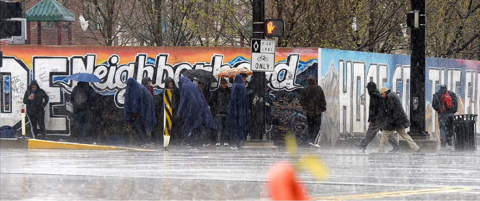 Al Hartmann  |  The Salt Lake Tribune
Homeless endure the rain beneath blankets and umbrellas at the intersection of 500 Wesgt and 200 South during the pounding rainstorm Monday March 27.