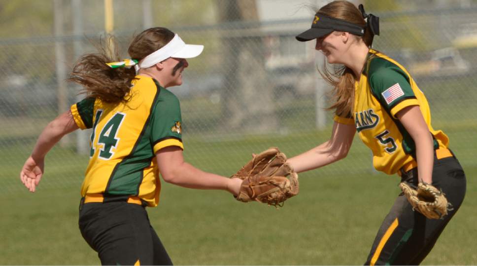 Leah Hogsten  |  The Salt Lake Tribune 
l-r Kearns' Tristin Evans celebrates and out by second baseman Amanda Morris. Cyprus High School girls' softball team defeated Kearns High School 5-0 during their game Thursday, April 13, 2017 in Magna.