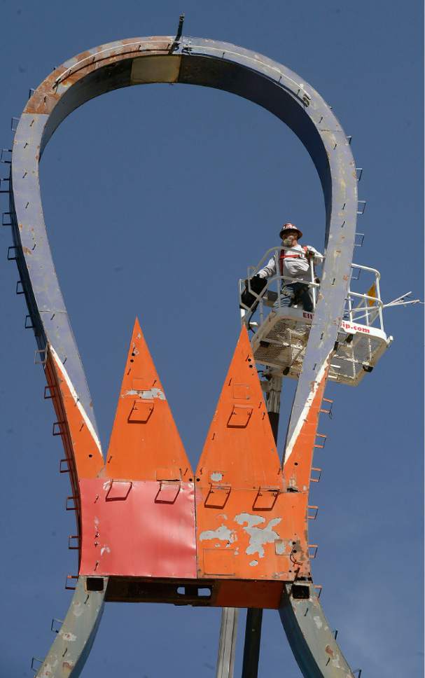 Al Hartmann  |  The Salt Lake Tribune
Yesco Sign Company's Mike Valdez on high lift begins to disassemble the metal frame of the iconic Ritz Classic Lanes sign at 2265 S. State St.  Wednesday April 12.  The job should take a couple days.  Not to worry.  After being taken apart it will renovated and put back up again.