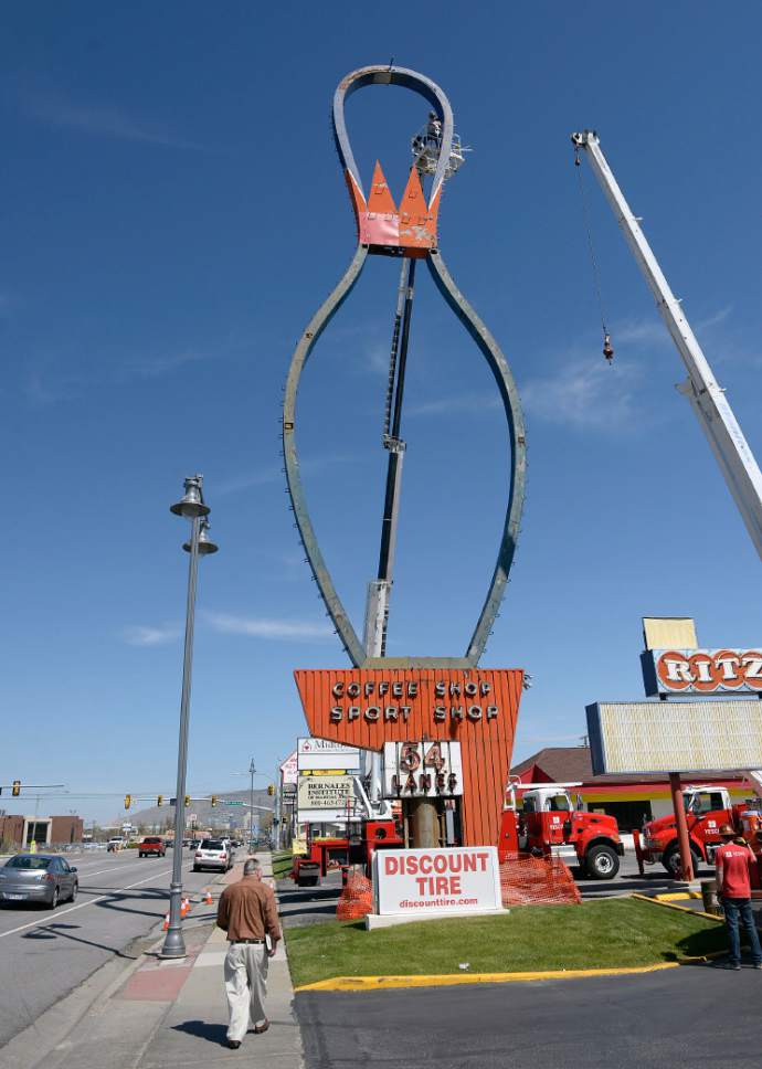 Al Hartmann  |  The Salt Lake Tribune
Metal outline frame of the iconic Ritz Classic Lanes sign at 2265 S. State St. is being taken down by workers on high lifts Wednesday April 12.  The job should take a couple days.  Not to worry.  After being taken apart it will renovated and reassembled.