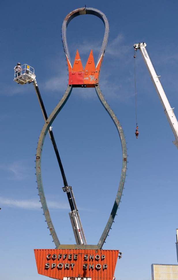 Al Hartmann  |  The Salt Lake Tribune
Metal outline frame of the iconic Ritz Classic Lanes sign at 2265 S. State St. is being taken down by workers on high lifts Wednesday April 12.  The job should take a couple days.  Not to worry.  After being taken apart it will renovated and reassembled.