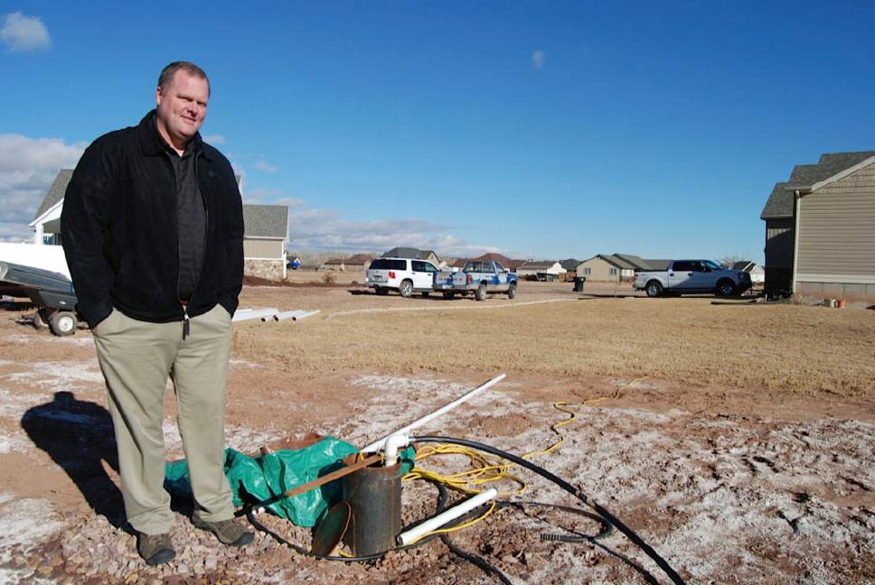 Brian Maffly  |  The Salt Lake Tribune

Andy Adamson, a homeowner in the Stonegate subdivision west of Roosevelt, inspects a well the county dug next to his lot in an unsuccessful effort to lower the water table that is damaging foundations and rendering septic systems useless. Duchesne County could impose a moratorium on residential construction in its unincorporated Hancock Cove until this subdivided agricultural area can be sewered.