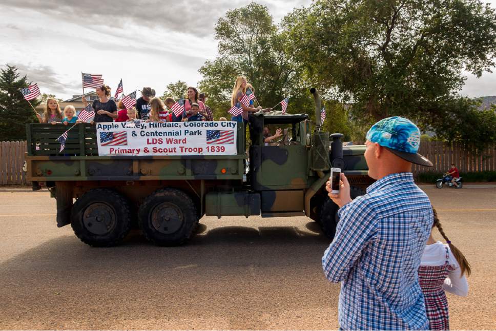 Trent Nelson  |  The Salt Lake Tribune
Members of a local LDS ward wave flags as the Colorado City and Hildale Fourth of July Parade makes its way down Central Street in Hildale, UT, and Colorado City, AZ, as part of an Independence Day celebration Saturday July 2, 2016.