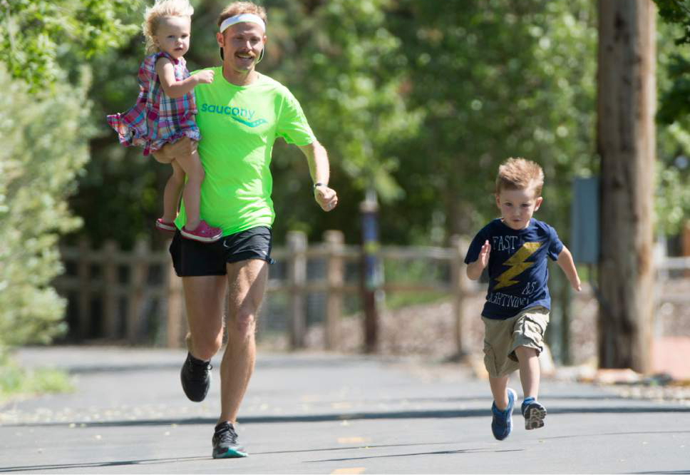 Rick Egan  |  The Salt Lake Tribune

Former BYU distance runner Jared Ward, holds his 2-year-old Ellie, as he races his 4-year-old son Paul, on the Rail Trail in Park City, Tuesday, June 21, 2016.