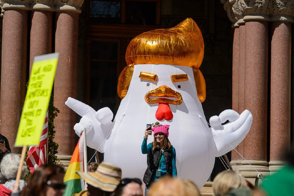 Trent Nelson  |  The Salt Lake Tribune
Anna McNamer takes a selfie in front of "Chicken Don" during a rally calling for President Trump to release his tax returns, which took place at the Salt Lake City and County Building, Saturday April 15, 2017.