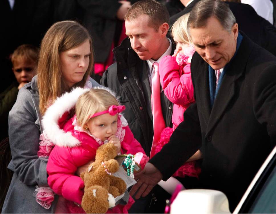 Leah Hogsten  |  The Salt Lake Tribune
Robbie Parker carries daughter Madeline, 4,  and Alissa Parker carries Samantha, 2, from the funeral service for their oldest daughter Emilie, Saturday December 22, 2012 in Ogden. Funeral services for Connecticut elementary shooting victim Emilie Parker were held in Ogden at the at the Rock Cliff LDS Stake Center. Emilie, whose family has Ogden roots, was one of 20 children and six adult victims killed in the Dec. 14 mass shooting at Sandy Hook Elementary in Newtown, Conn. The shooting took the lives of 26 people, before the gunman killed himself.