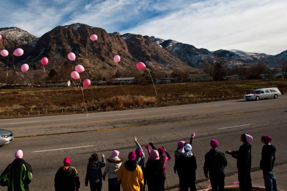Chris Detrick  |  The Salt Lake Tribune
High School students from around Davis County release pink balloons on the sidewalk along Monroe Blvd, as Emilie Parker's hearse passes on the way to Myers Evergreen Memorial Park Saturday December 22, 2012.  Emilie Parker, 6, was one of 20 children massacred by a gunman Dec. 14 at Sandy Hook Elementary School in Newtown, Conn.