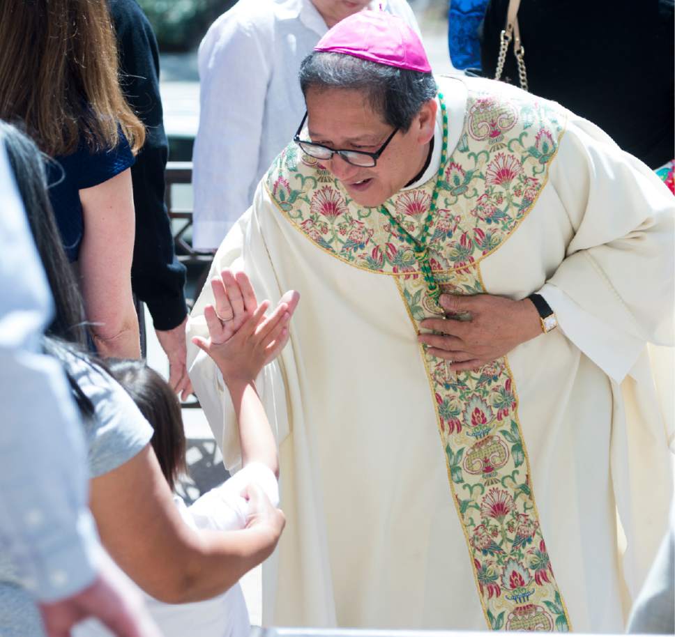 Rick Egan  |  The Salt Lake Tribune

The Most Reverend Oscar A. Solis' high-fave's a youngster after Easter Mass, at the Cathedral of the Madeleine, Sunday, April 16, 2017.