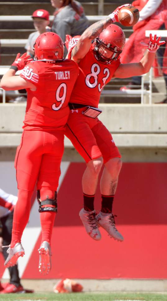 Leah Hogsten  |  The Salt Lake Tribune 
Wide receiver Jameson Field celebrates his touchdown with teammate Austin Turley.  The University of Utah Utes were back in action  during the 16th-annual Red-White football game on Saturday, April 15, 2017 at  Rice-Eccles Stadium.